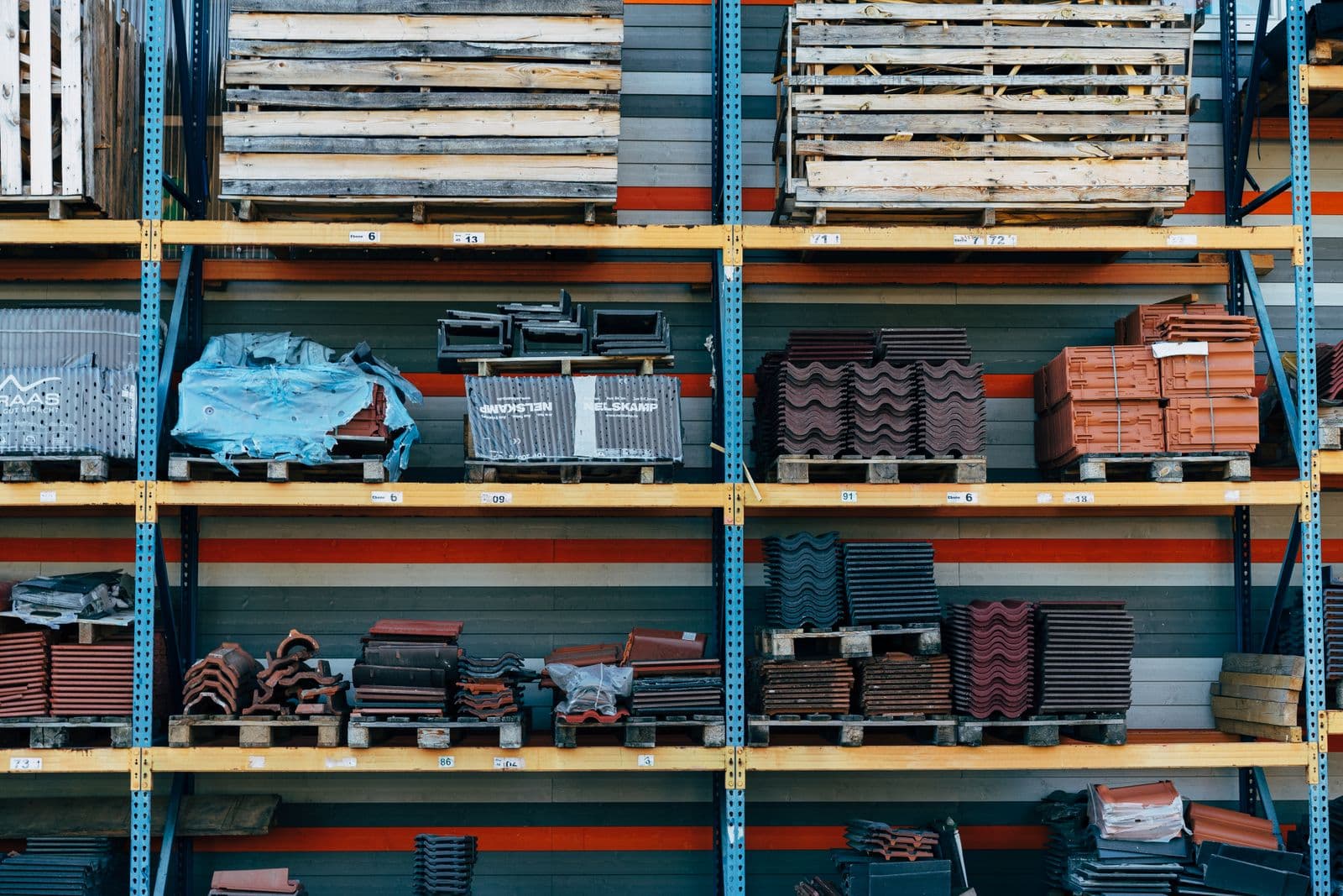 Organized construction-materials supplier racks (tiles, pallets) - materials marketplace/catalogue vibe