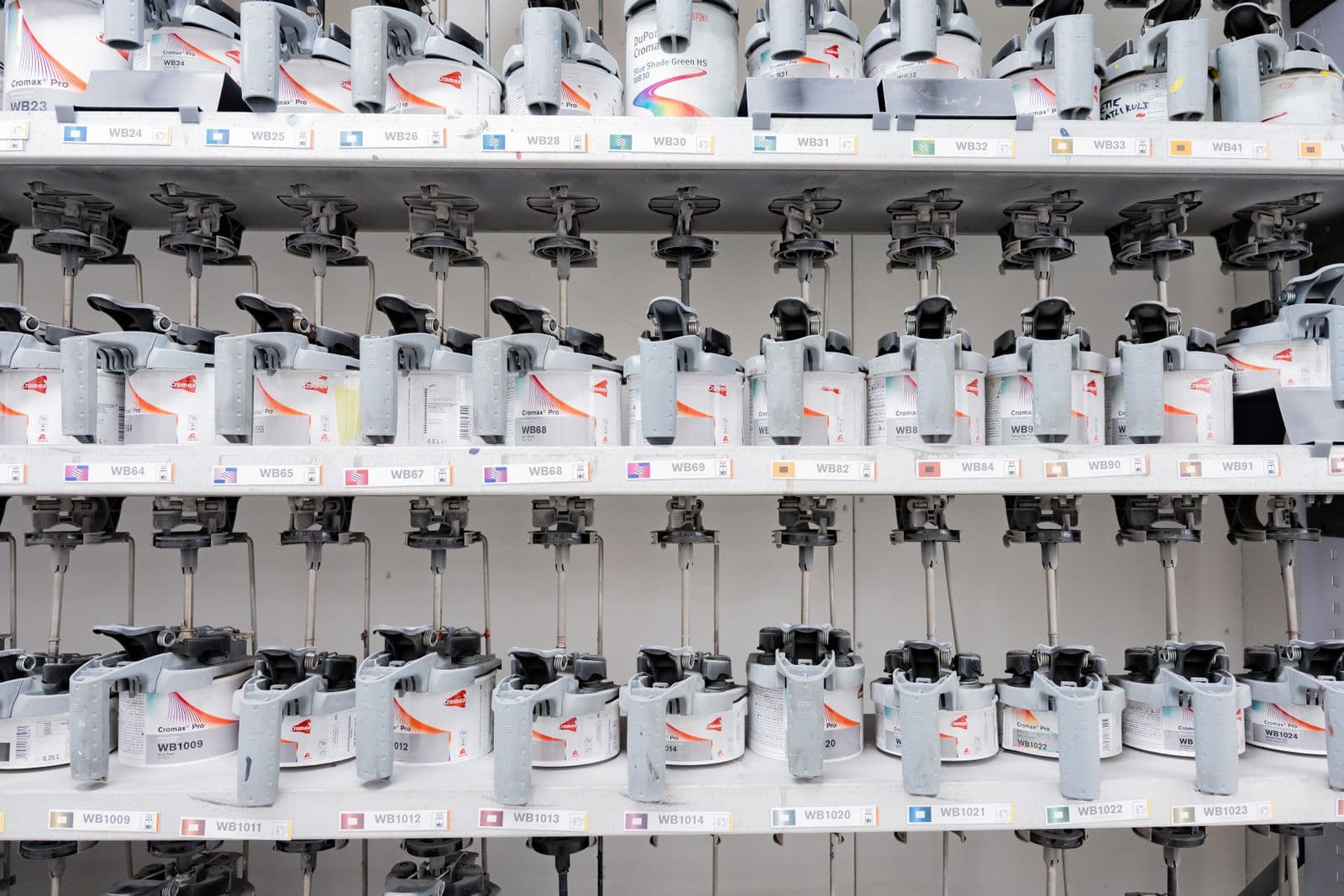 Row of industrial paint-tinting dispensers (no readable brand/faces)